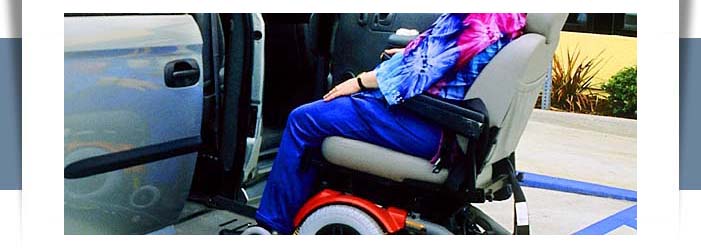 wheelchair user using lift into van